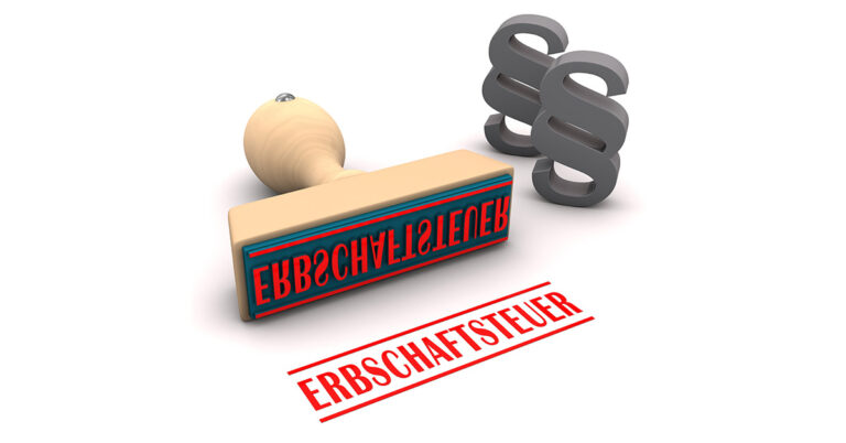 Ein Stempel mit dem Wort "Erbschaftssteuer" und zwei Zeichen für Paragraphen auf einem weißen Hintergrund - Erbschaftssteuer